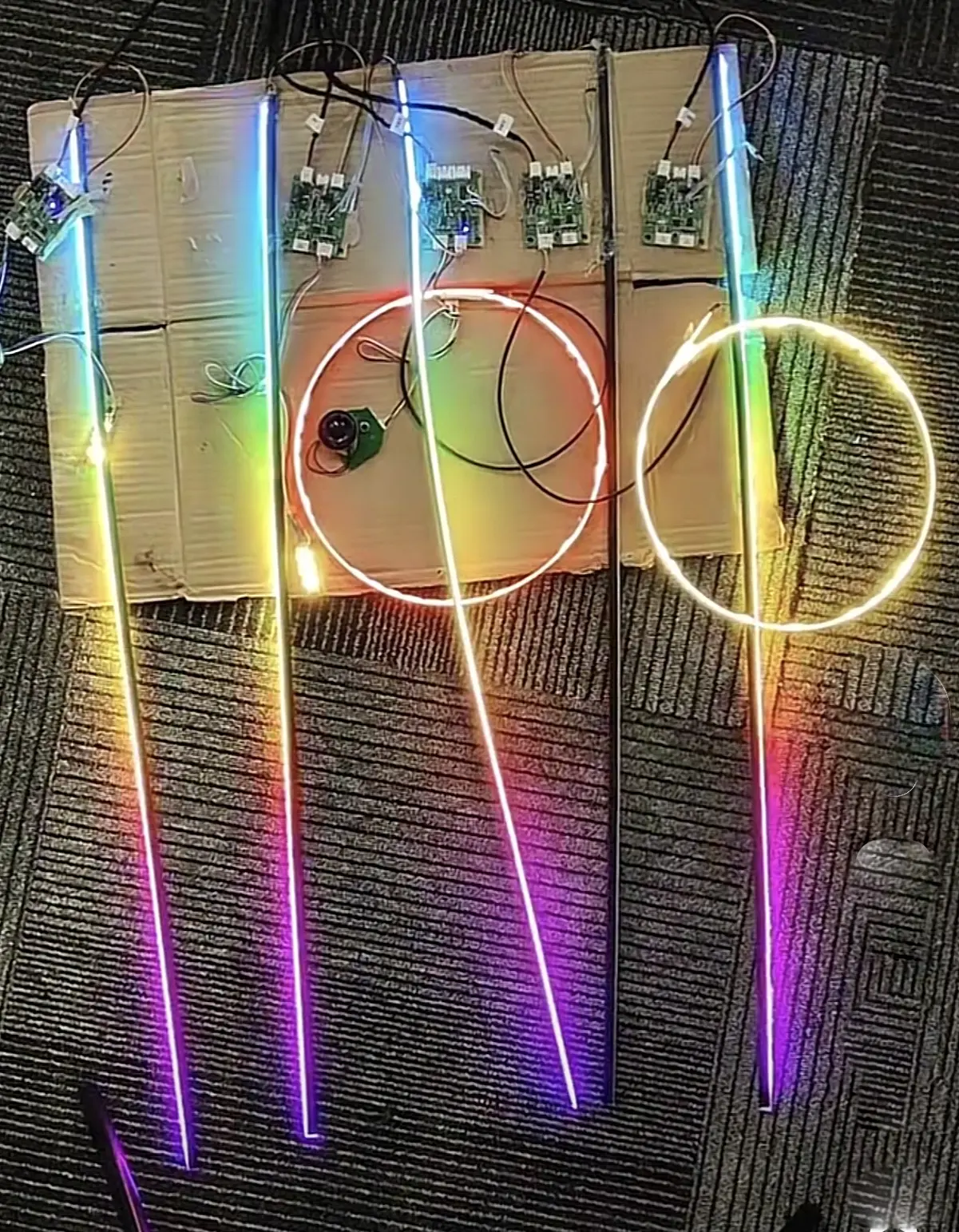 Car ambient lighting kit with control boards and illuminated light guides during testing.